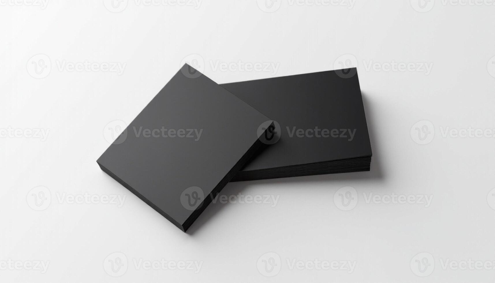 Two black square boxes on a white surface photo