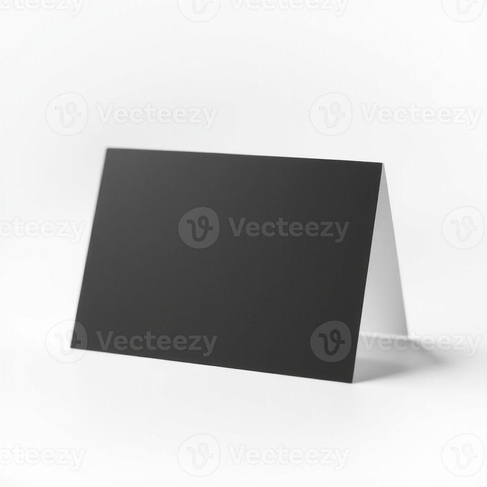 A blank black card on a white surface photo