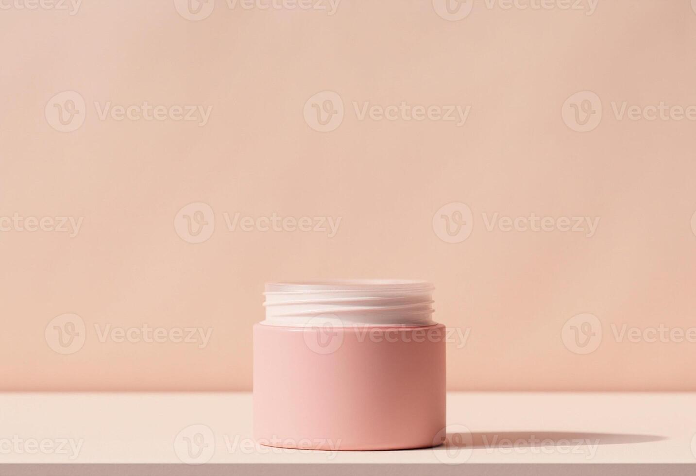 A pink jar with a white lid on a table photo