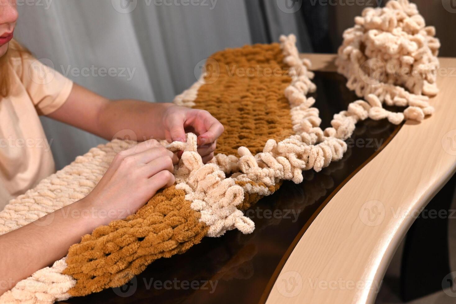 Creative project in a cozy indoor setting, showcasing a person working on a handmade textile piece using modern techniques photo