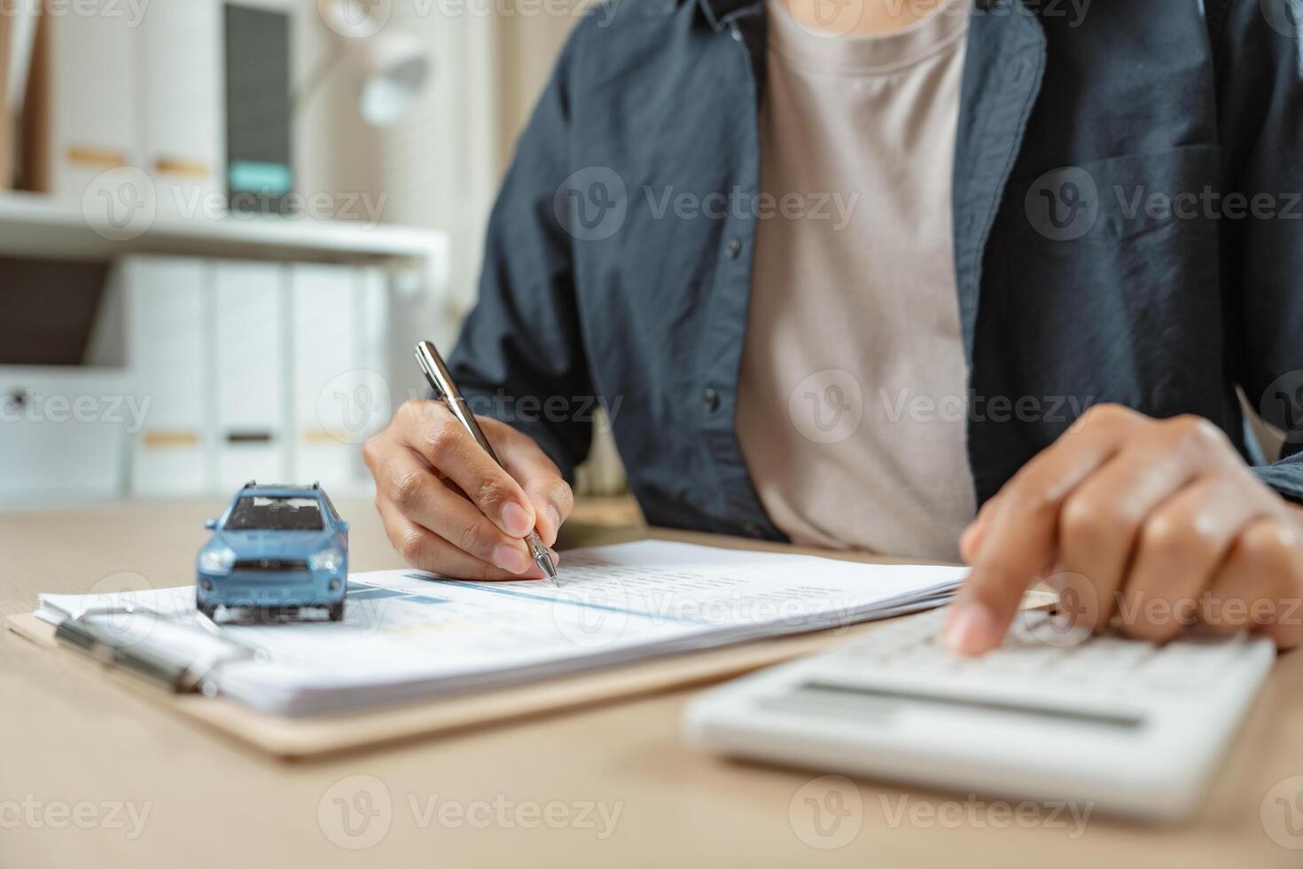 Man signing car insurance on paperwork assurance. Buying or selling new vehicle. Ownership for new photo
