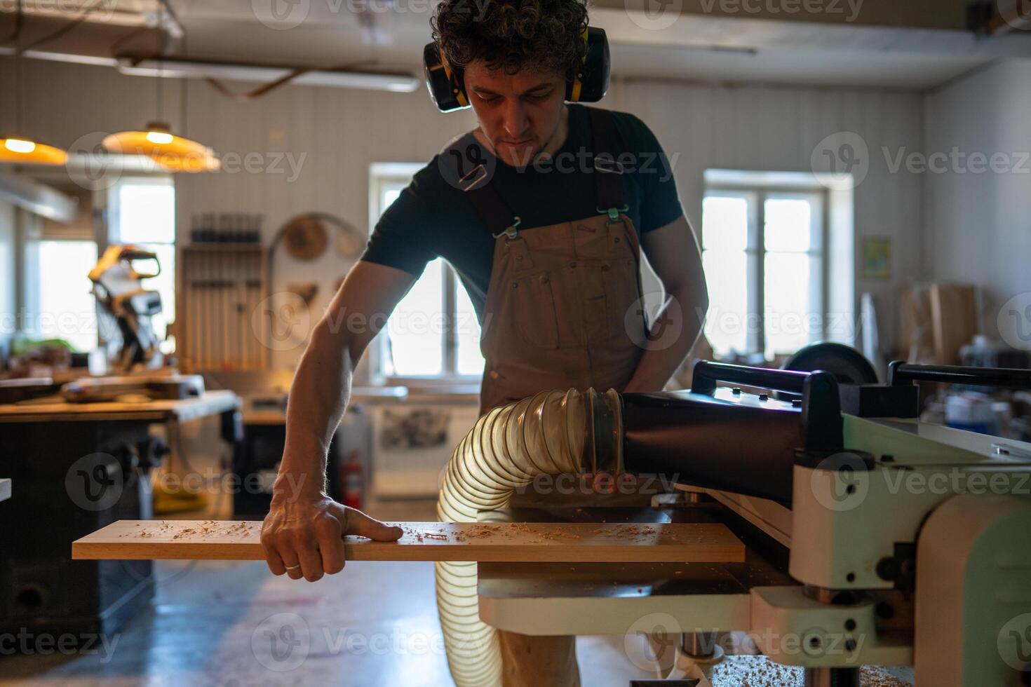 Concentrated craftsman using band saw machine in studio, finalizing project for customer handover photo