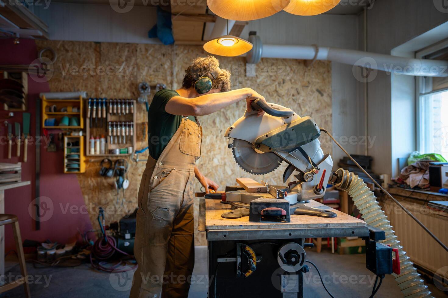 Meticulous craftsman carefully maneuvers mitre saw cutting wood beams. Joinery smoothing techniques photo