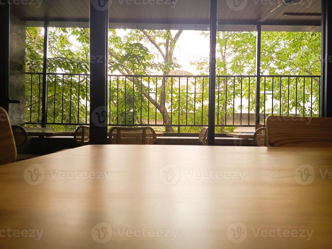 Wooden Table with Green Tree View in Modern Interior photo