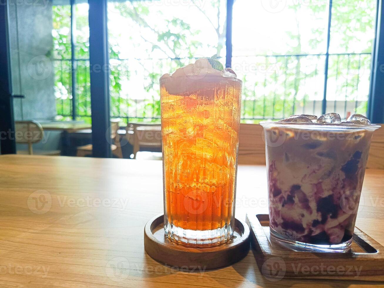 Iced Teas Refreshing Drinks on Wooden Table in Bright Cafe photo