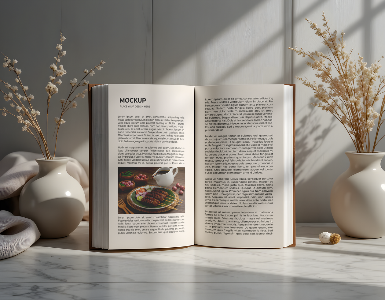 Open book mockup with dried flowers and marble surface psd