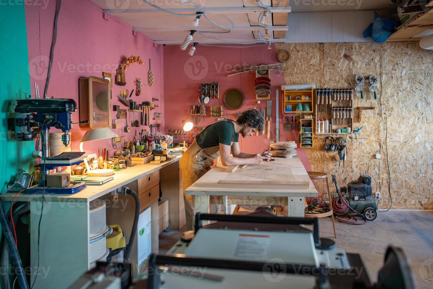 Dedicated woodworker examines smartphone order details while preparing online materials in workshop photo