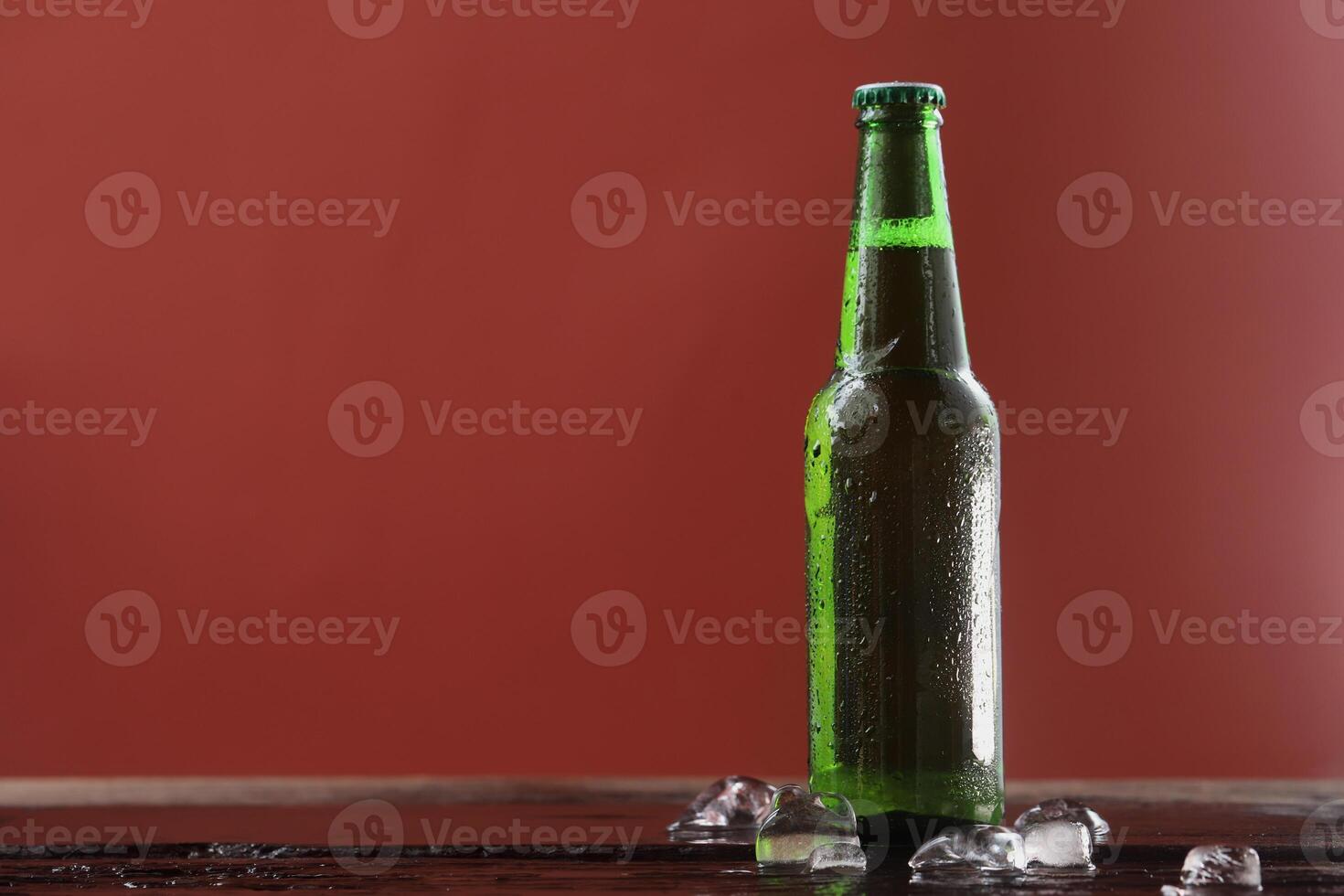 cold green beer bottle comes with refreshing touch. photo