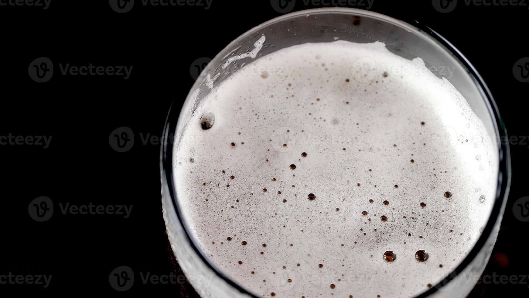Cold beer with foam in a glass ready to drink photo