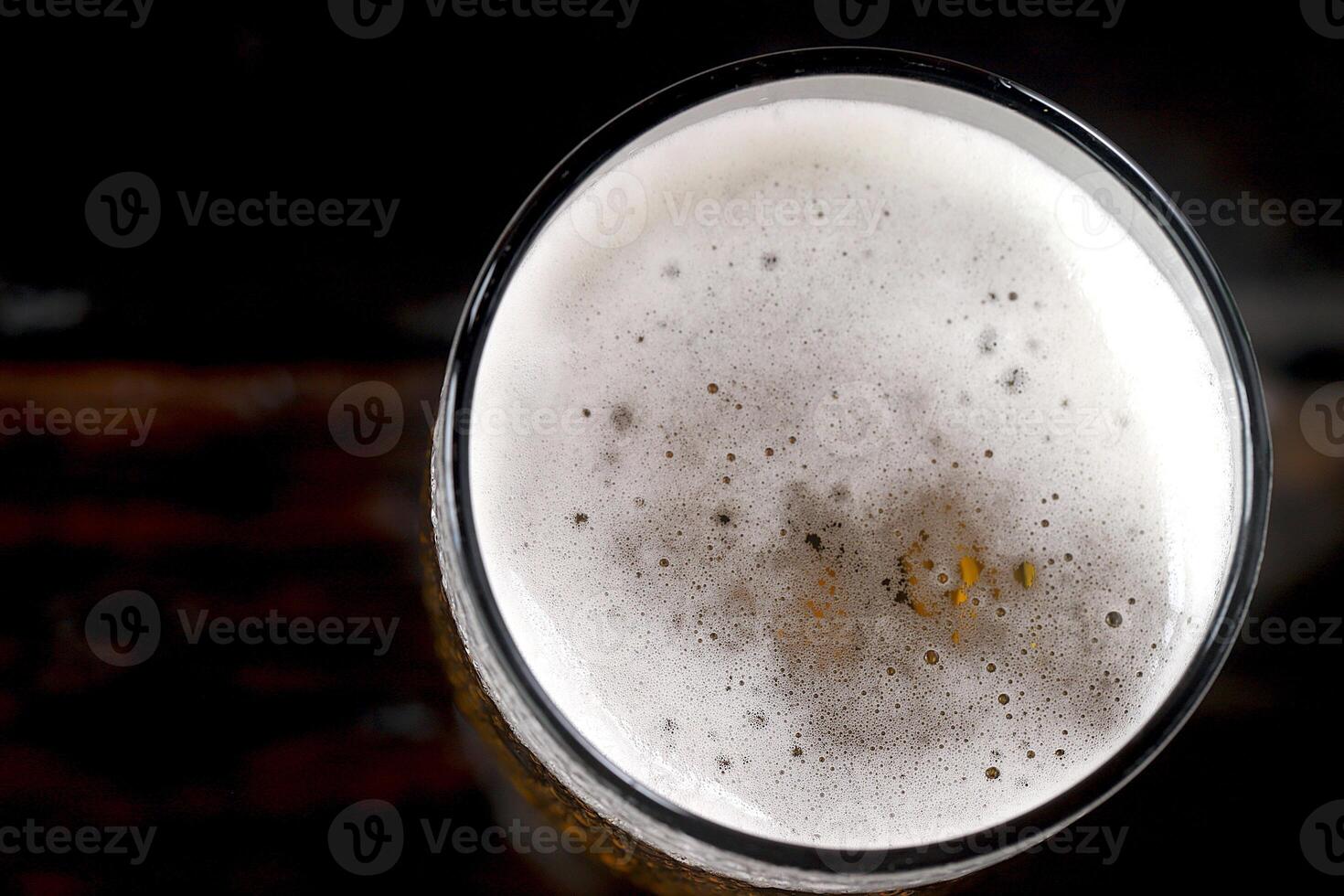 Cold beer with foam in glass ready to drink. photo