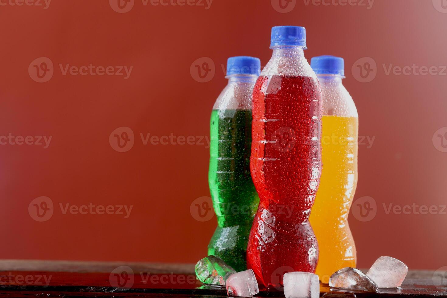 Soft drink bottle with a red background photo