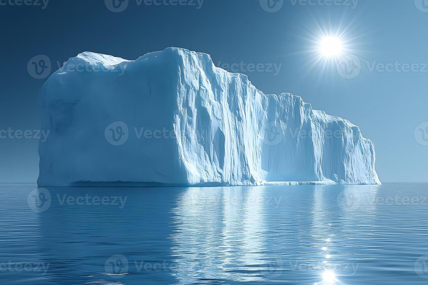 Majestic Arctic Iceberg Under a Bright Sun Reflected on Calm Ocean Waters photo