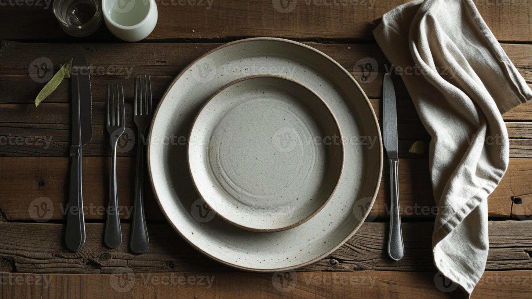 A table setting with a plate, fork, knife and napkin photo