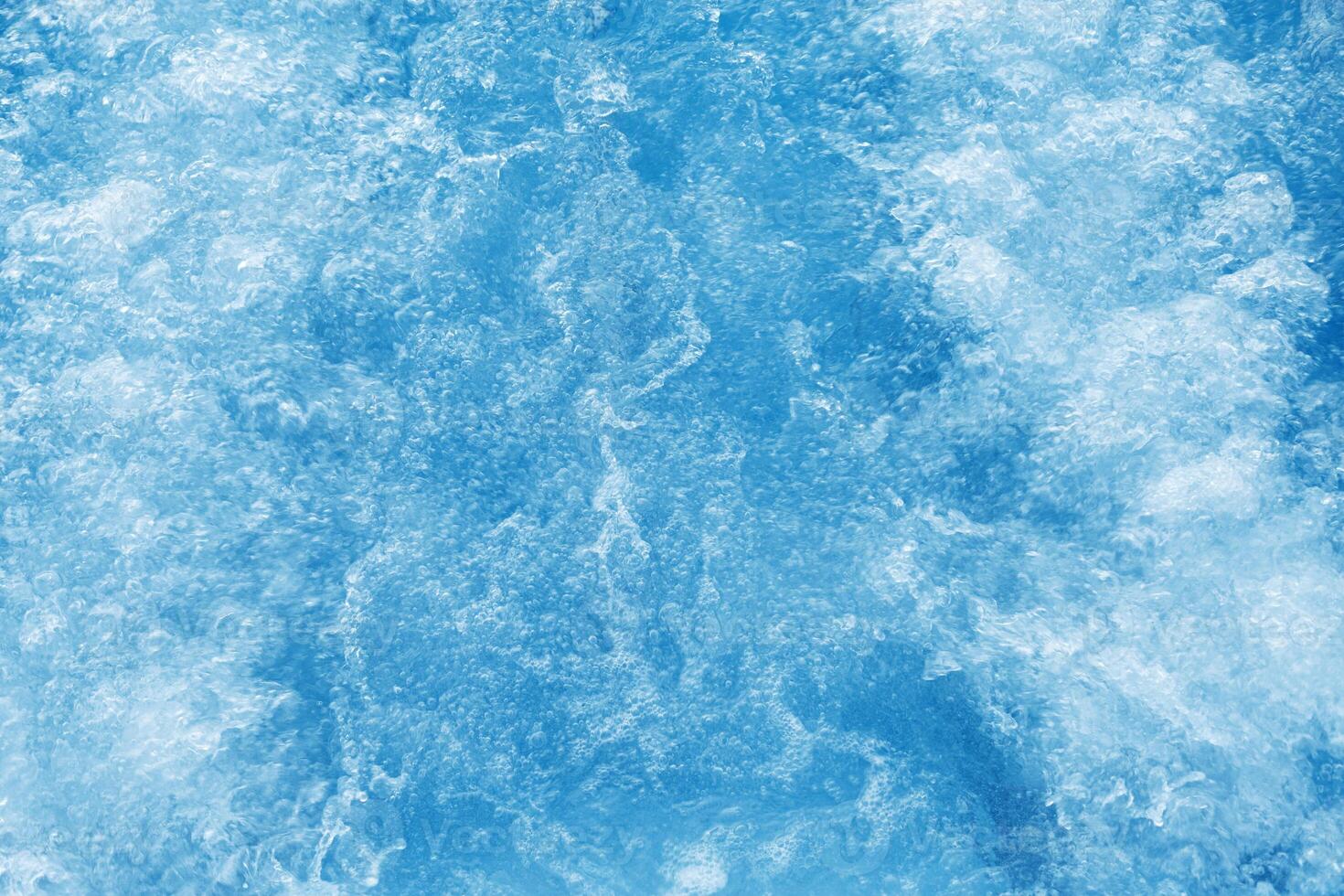 Bubbling water texture, flow thermal water as abstract background macro photo, spa and wellness theme, gentle ripples and gurgling on white blue aquatic surface, sea color gradient photo