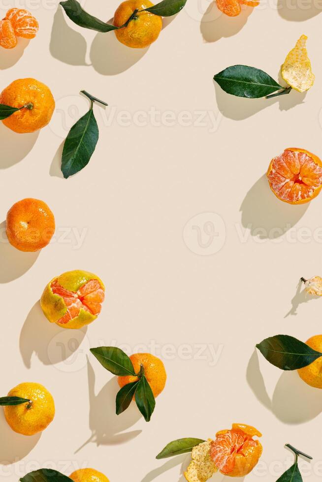 Top view juicy orange yellow tangerines as trend pattern minimal style, Natural citrus fruit with green leaf on light beige background. Organic, healthy, vegetarian and plant-based food, pastel tone photo