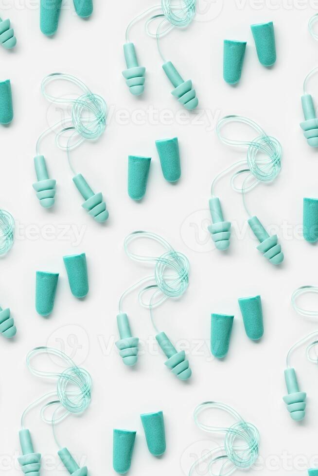 Different earplugs as minimal pattern, comfort silicone and rubber ear plug on string protection against noise, protect hear, for swim, sleep, rest. Top view flat lay photo pattern