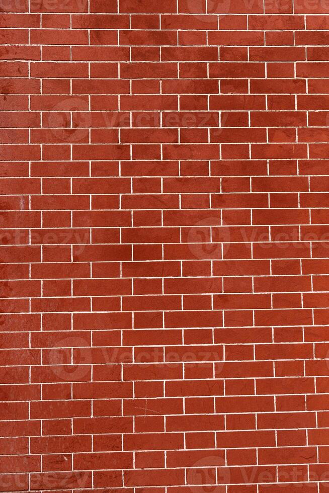 Brick wall is bright red, texture of stone blocks, background of bricks. photo
