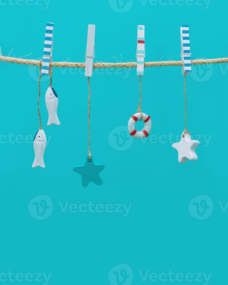 Marine or nautical themed background, summer sea toys lifeline, starfish and small fish hanging photo