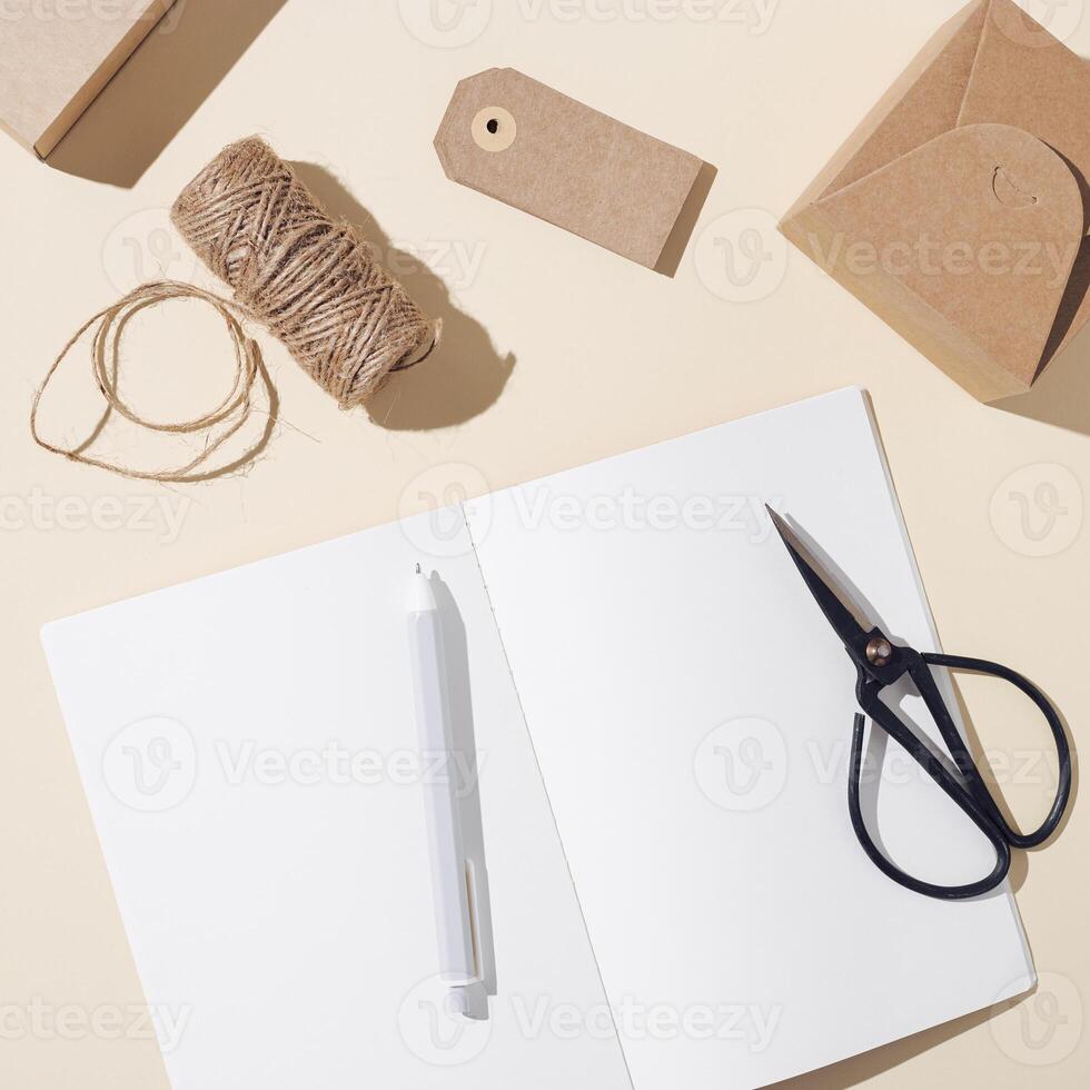 Open notebook with blank pages and craft paper box decorated natural autumn plant poppy. Autumnal concept photo