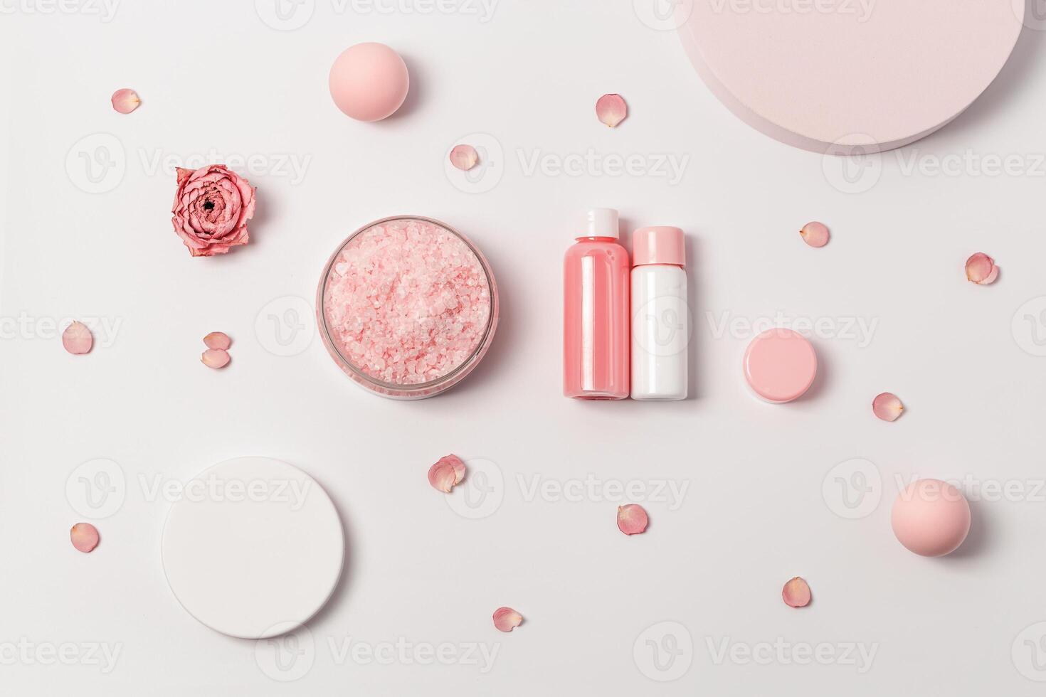 Aromatic crystals of sea salt with essential oil flower of rose. Spa composition with cosmetic bathroom product top view photo