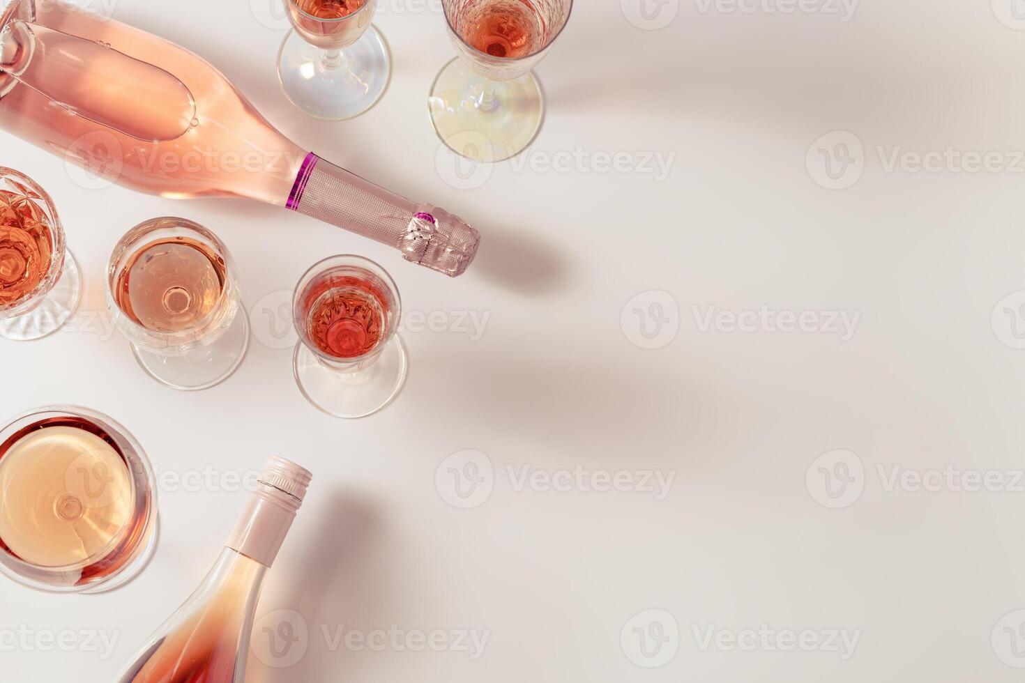 Rose wine assortment in crystal glasses, bottle of rose champagne sparkling wine. Summer alcoholic drink photo
