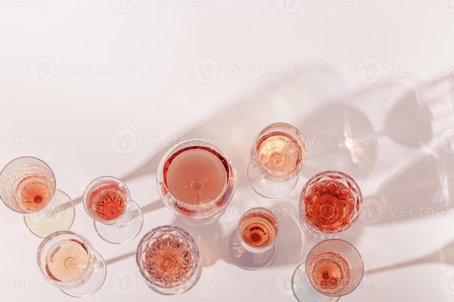Various glasses of rose wine or champagne sweet and dry, top view. Light alcohol sparkling drink for parties photo