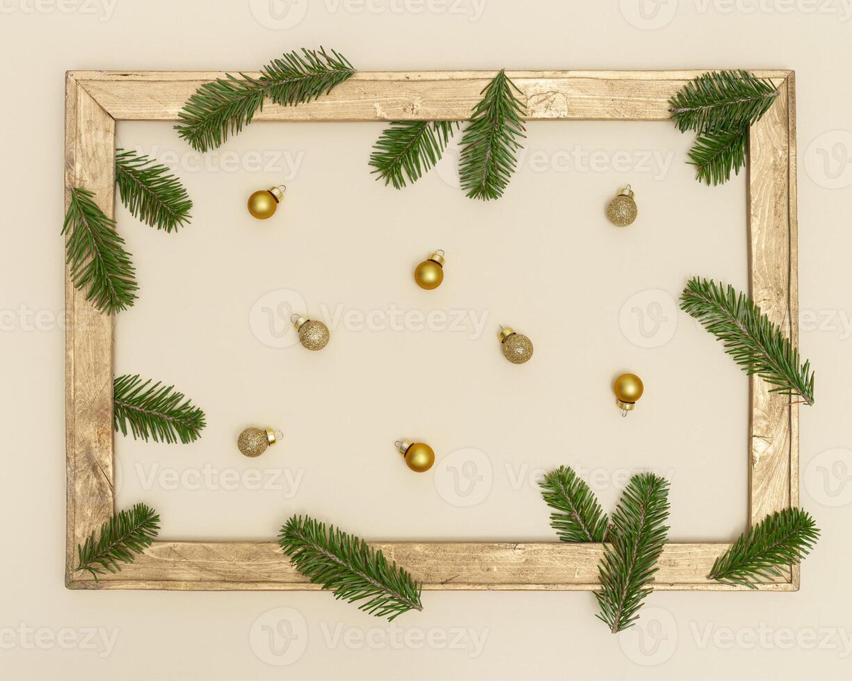 Christmas background with retro wooden frame with green fir branches and golden christmas balls photo