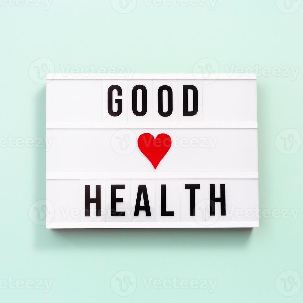 Healthcare and medical concept. Lightbox with words Good Health. Health wishes. Top view. photo