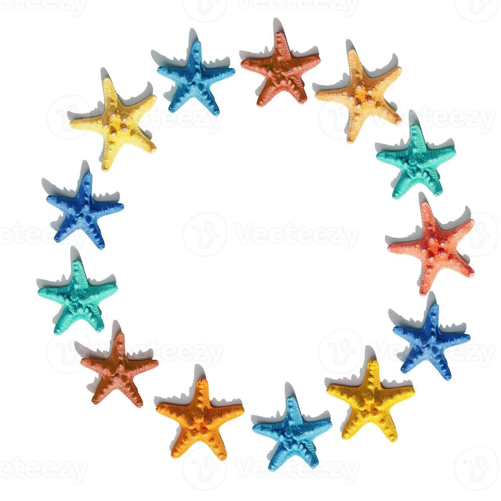 Round frame from colorful with colorful sea stars. Happy, bright and summer mood flat lay. photo