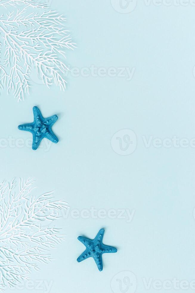 Summer flat lay with starfishes and coral on blue background. Summertime or beach concept photo