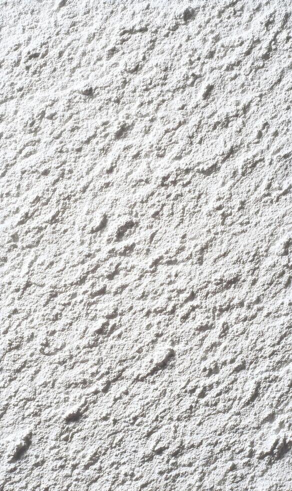 Rough textured surface casting shadows creating abstract patterns perfect for backgrounds and overlays with interesting depth photo