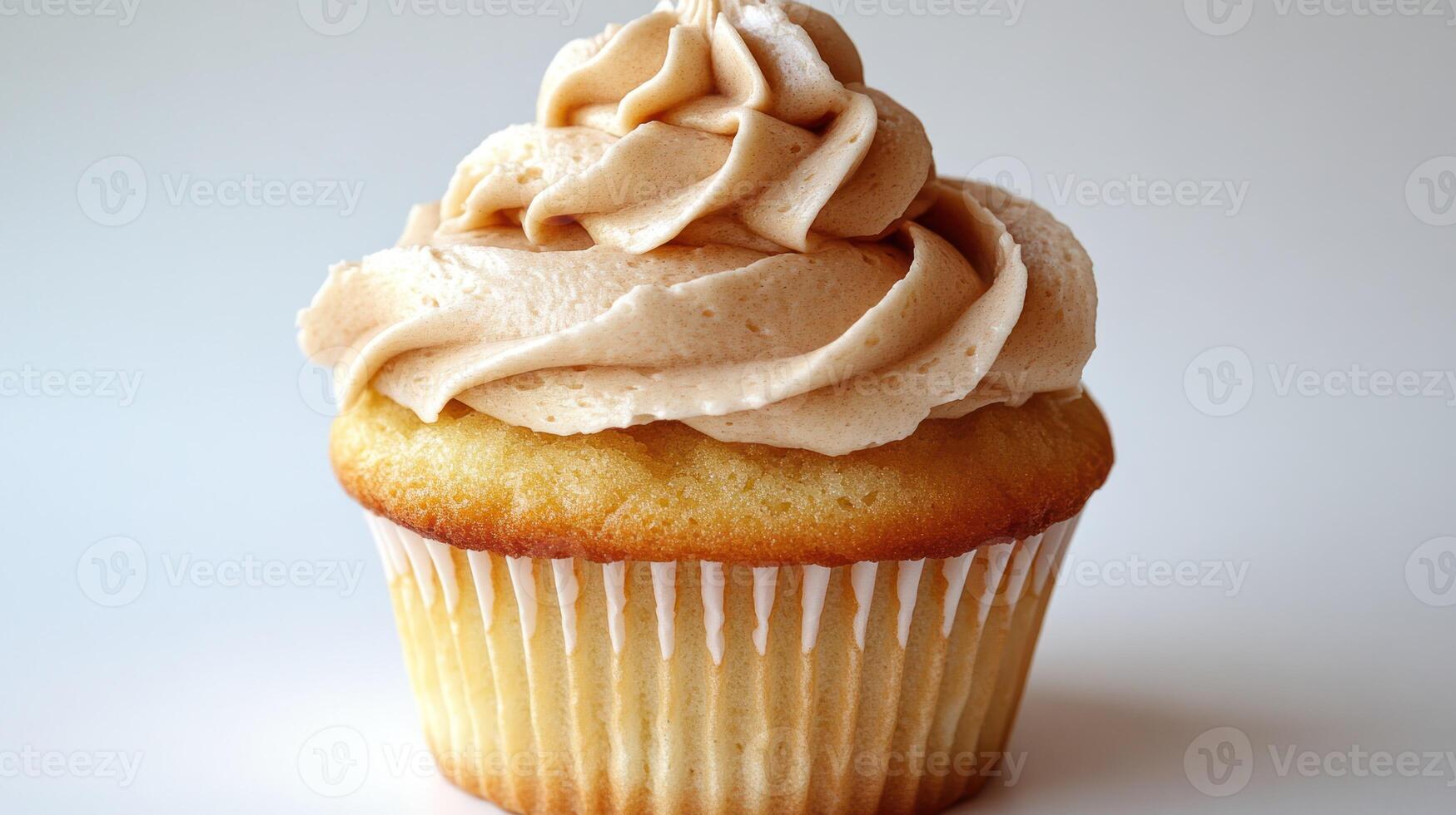 Delicious vanilla cupcake with a swirl of caramel frosting photo