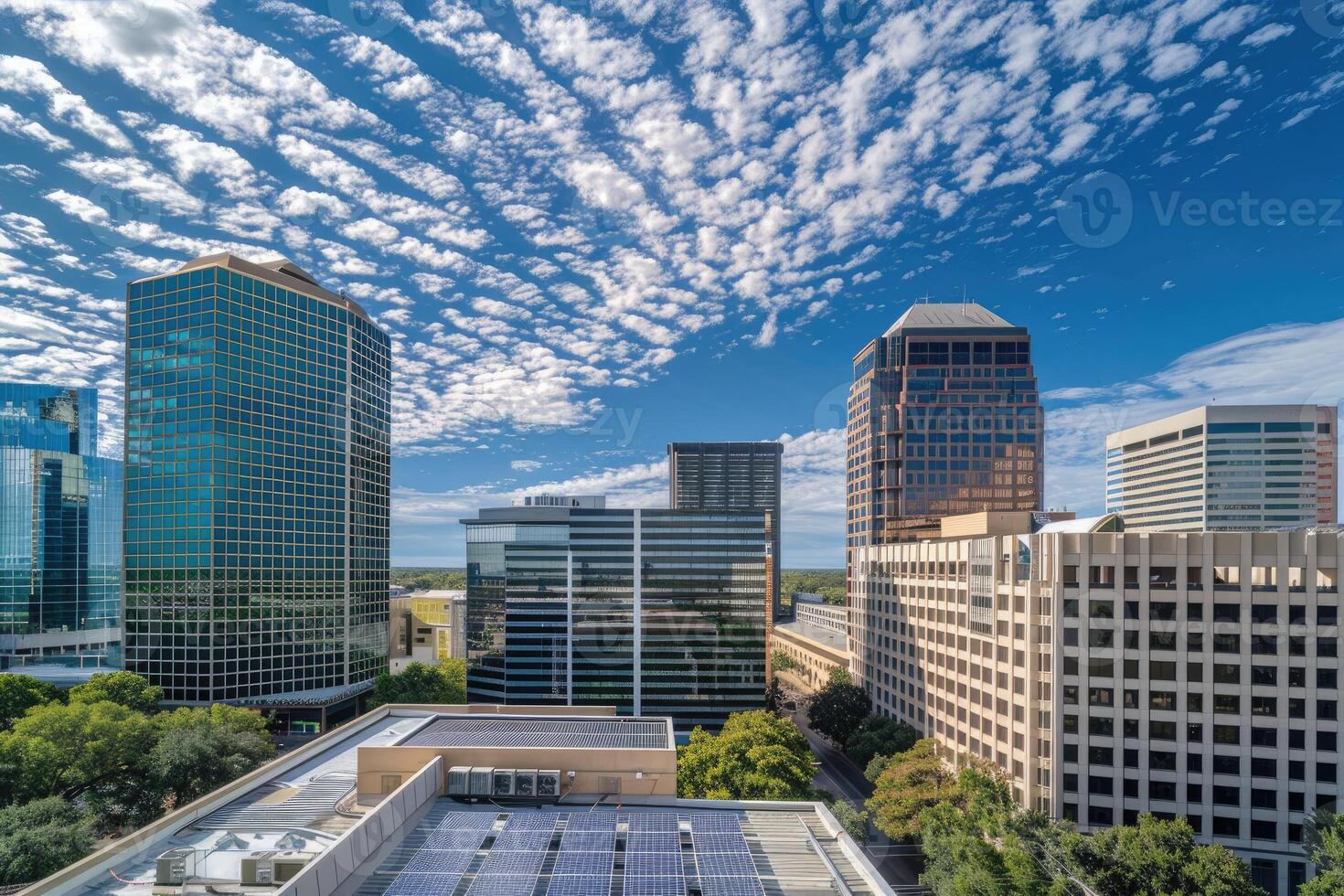 Cityscape featuring modern high rise buildings under a bright blue sky photo