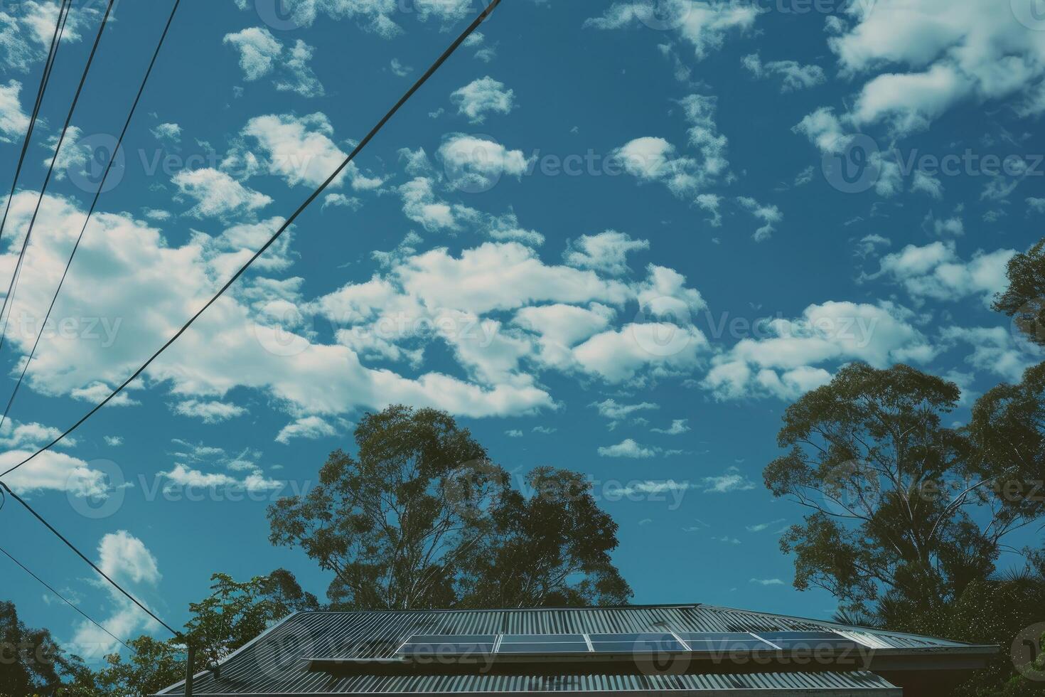 Solar Panels on a House Roof Under a Blue Sky photo