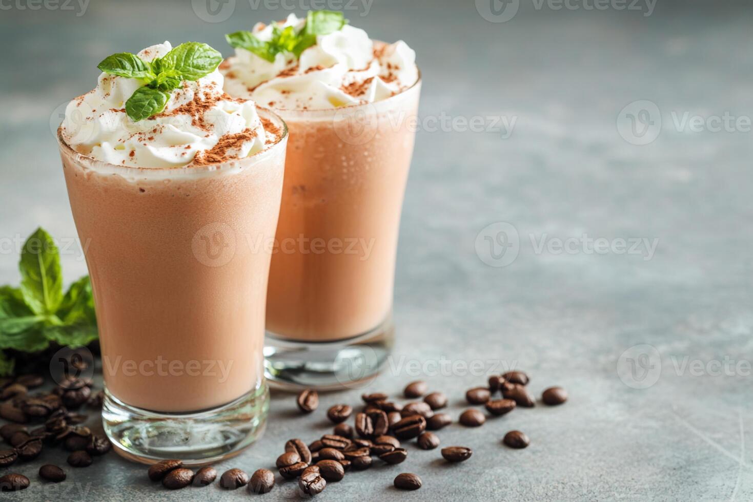 Two glasses of chocolate milkshake with whipped cream and mint leaves photo