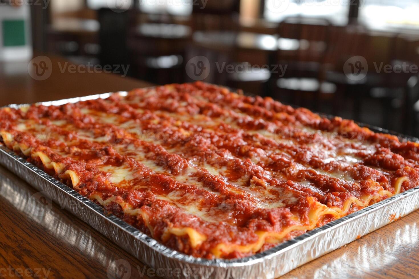 A large lasagna in a metal pan on a table photo