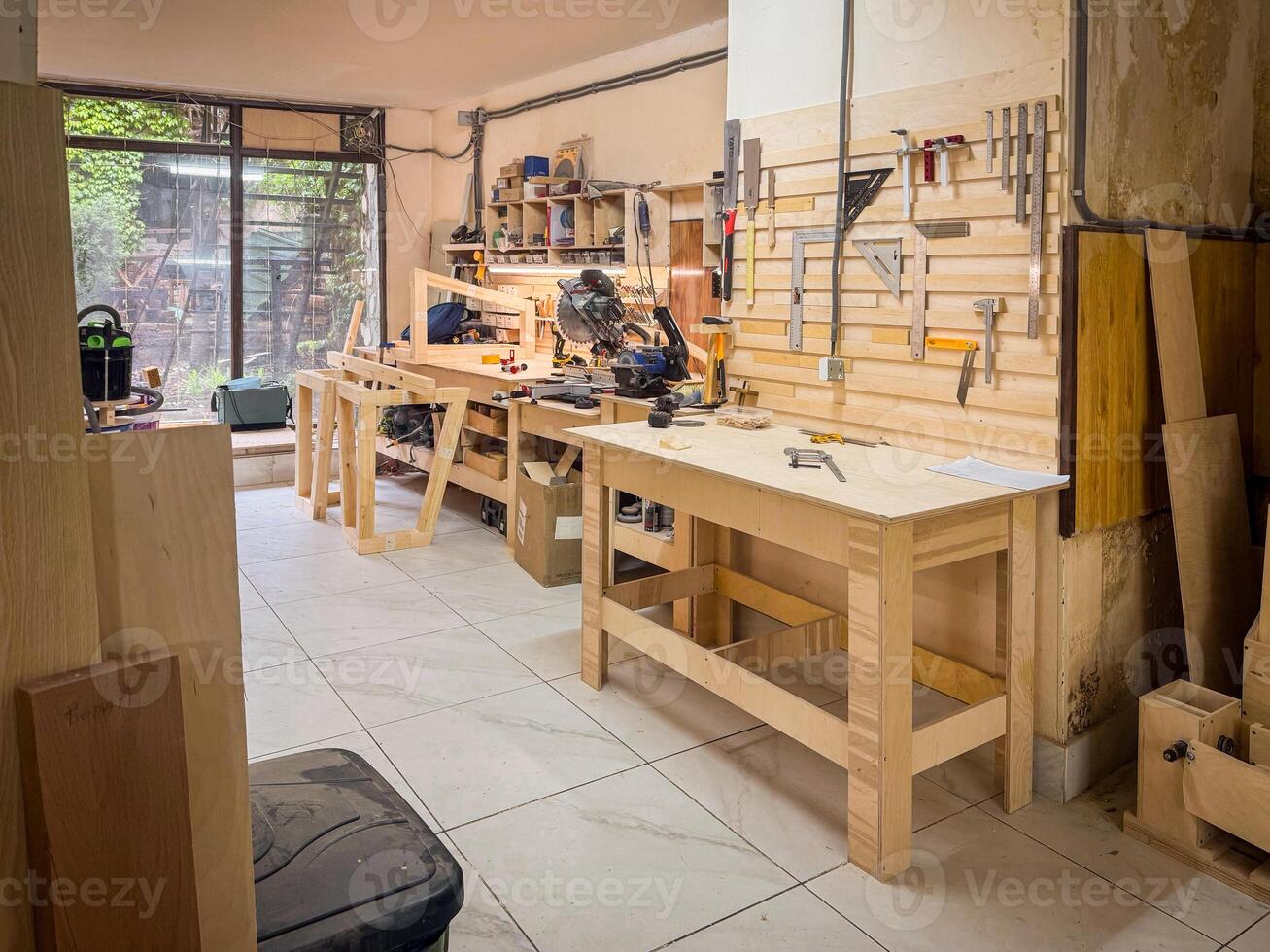Professional woodworking station with benches, mounted tools, clamps, rulers, and clean surfaces, designed for precision crafting and project planning photo