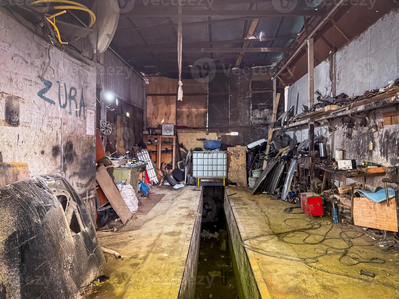 An auto mechanic workshop packed with tools, wires, and metal parts shows real industrial grit and functional chaos photo