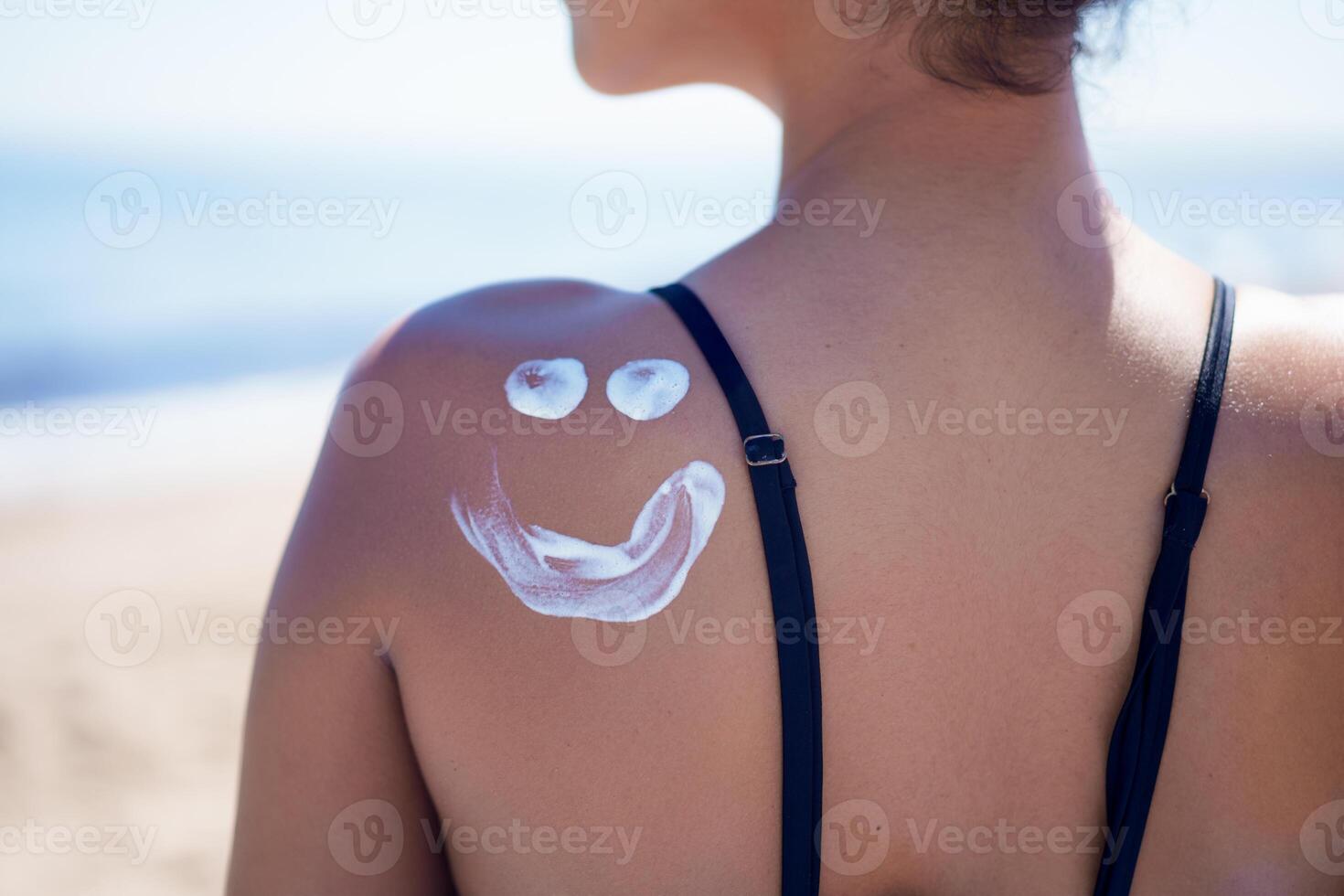 Enjoying a playful Sunscreen application on your face while relaxing on the shoulder at the beach photo