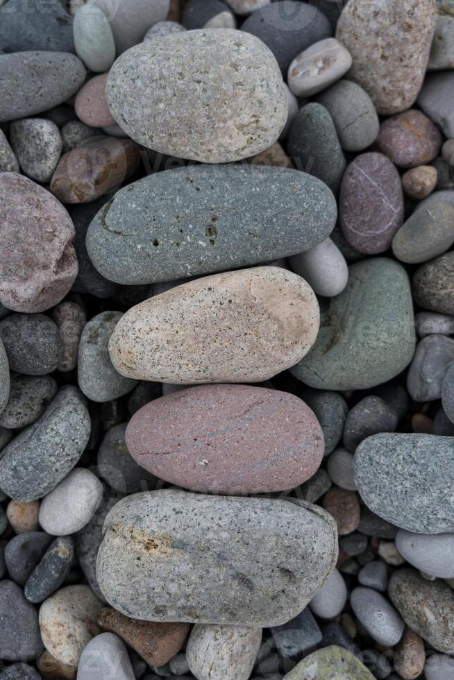 Stacked stones in a row on a stone background stone beach of Batumi photo