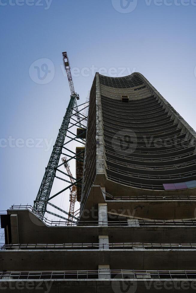 The construction of a skyscraper. Construction of a tall building photo