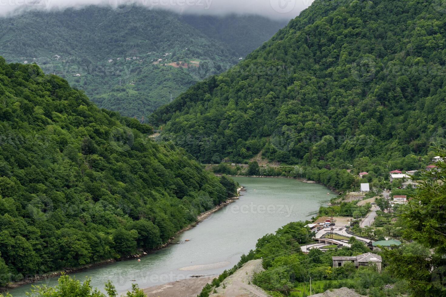 river running between the mountains of Georgia cloudy photo