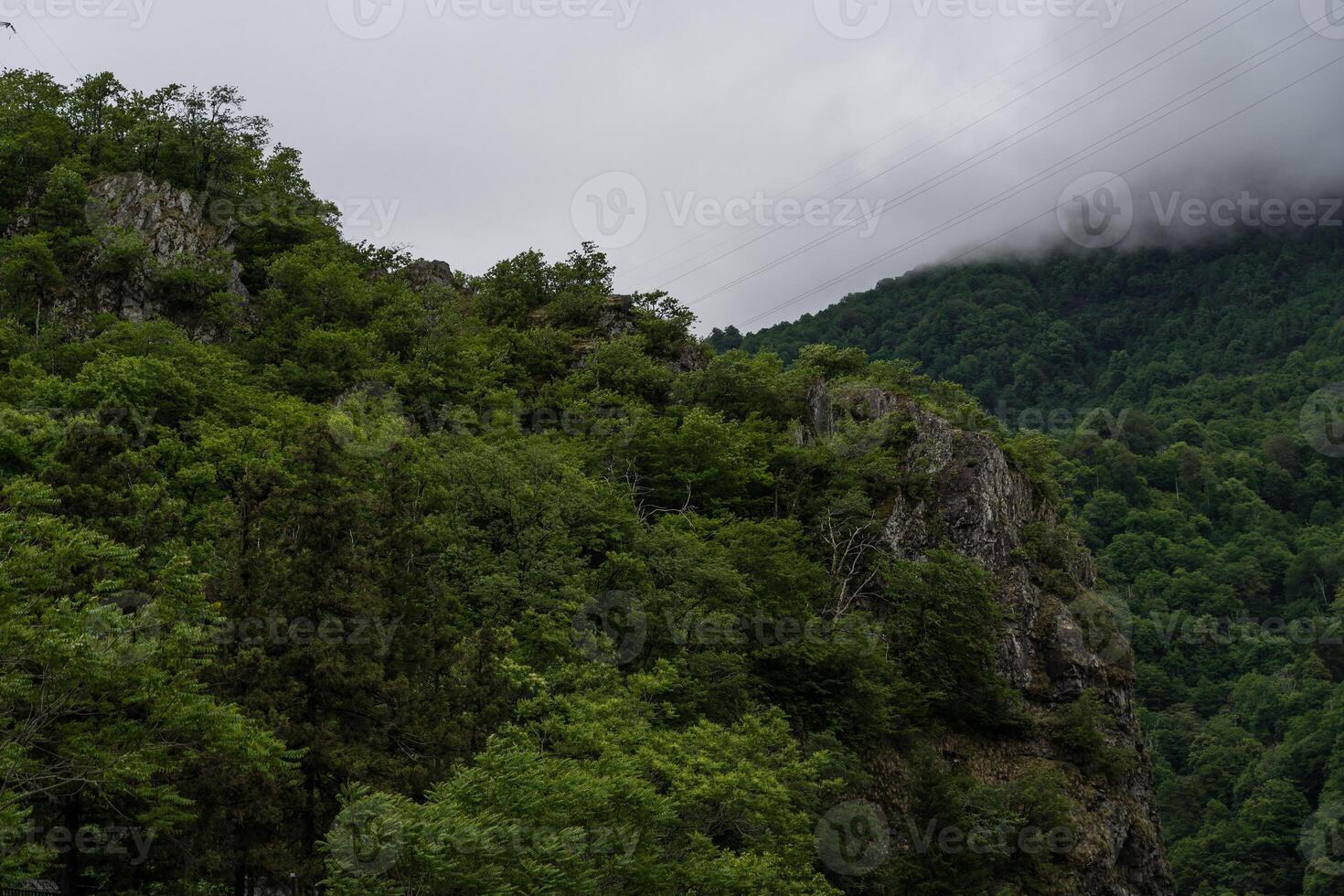 The mountains of Georgia are covered with thick clouds. Cloudy weather photo