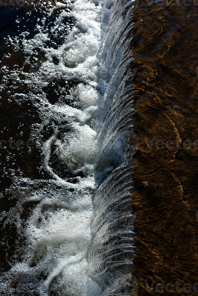 Waterfall view from above Falling water, foam from the waterfall. Winter photo
