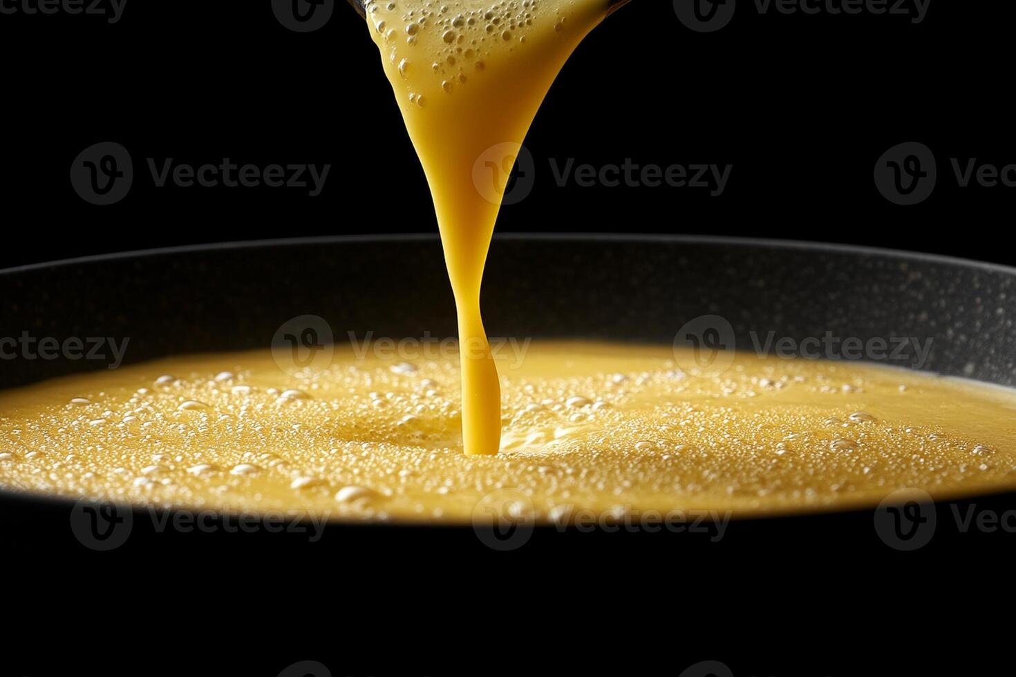 A pan being filled with yellow liquid photo