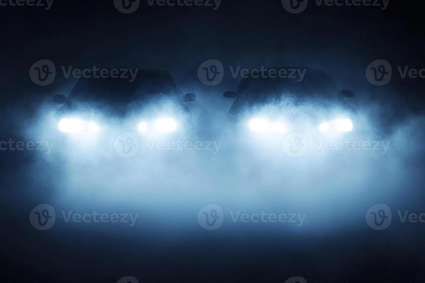 Two cars are seen in the dark with fog photo