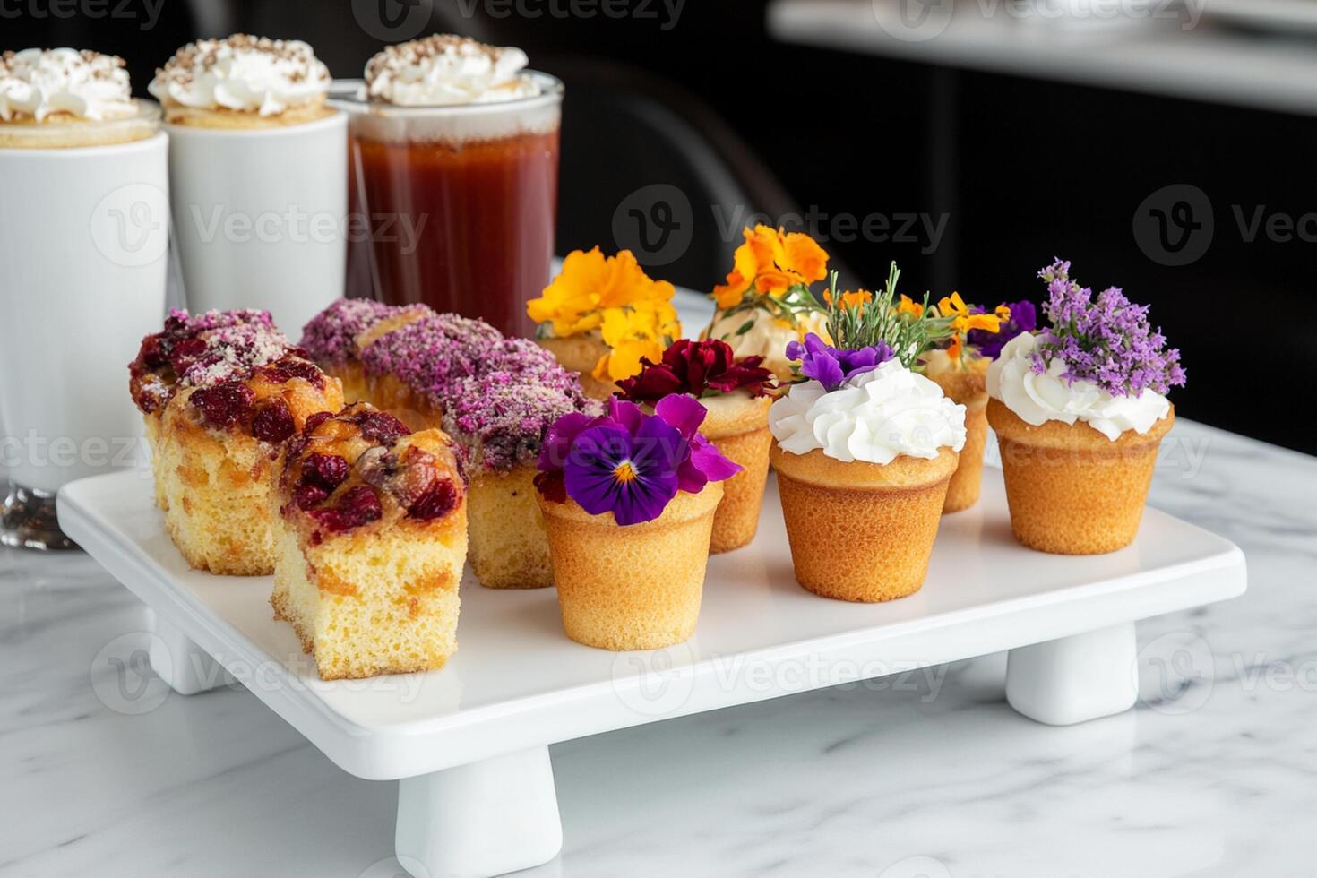 A white plate topped with cupcakes and other desserts photo