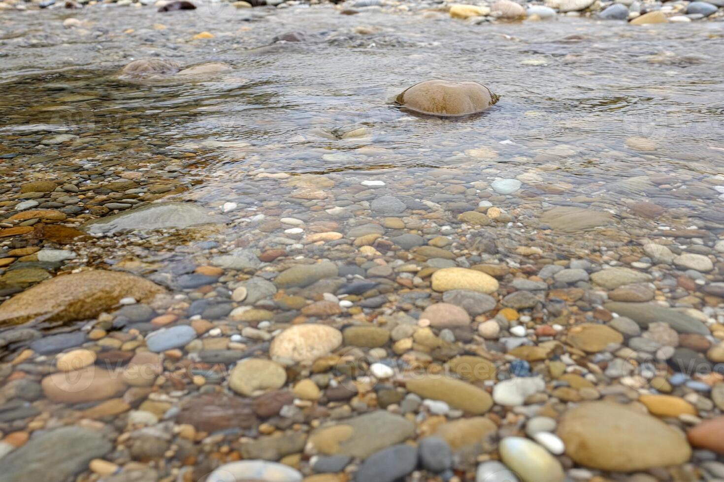 A river with rocks and pebbles in it photo