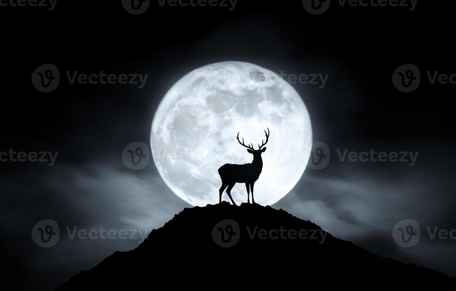 A deer stands on a hill in front of a full moon photo
