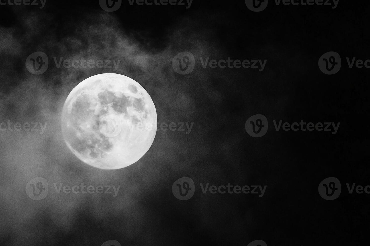 A full moon is seen in the dark sky with smoke photo